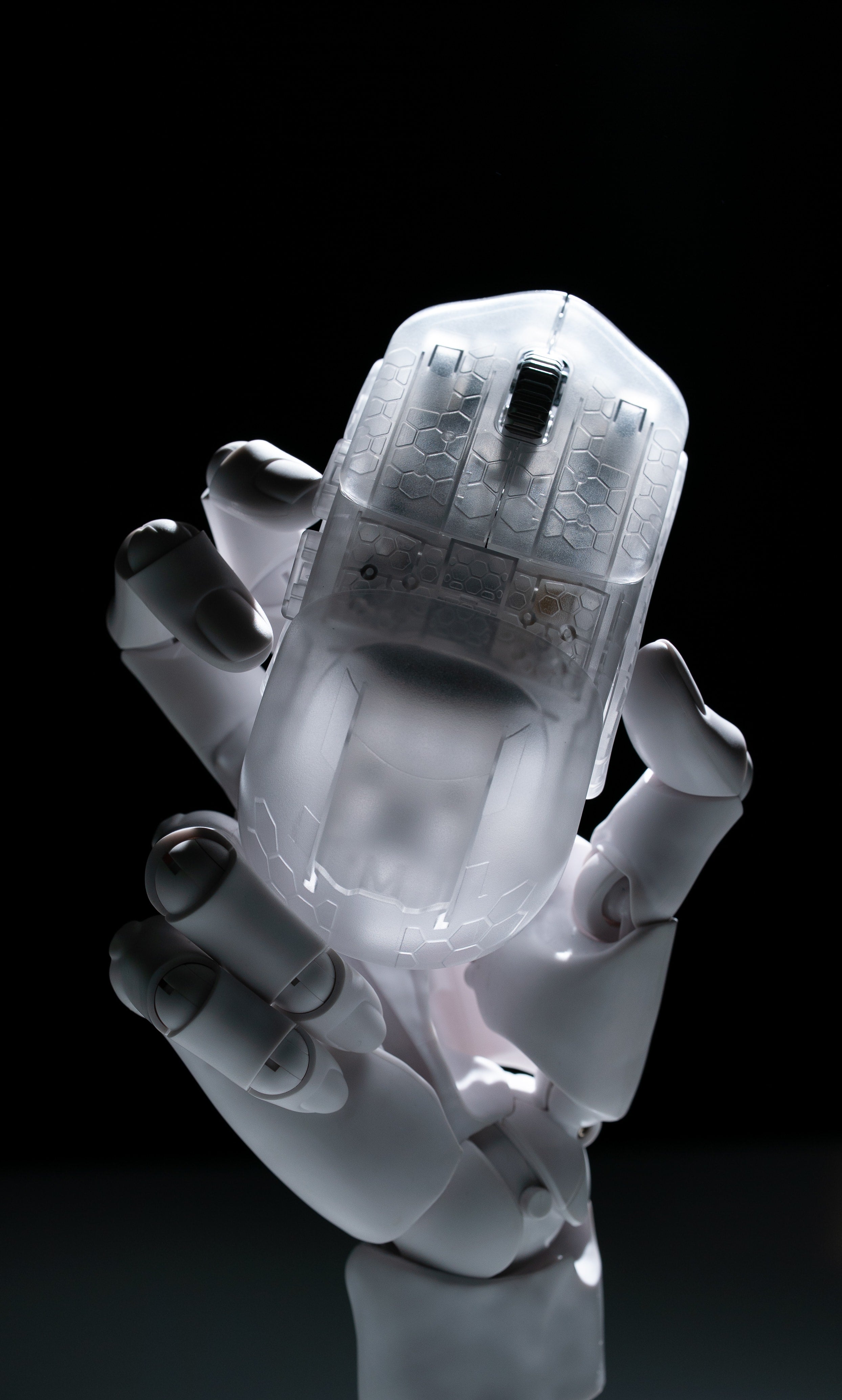 Pathfinder Ghost Edition mouse held in a white robot hand